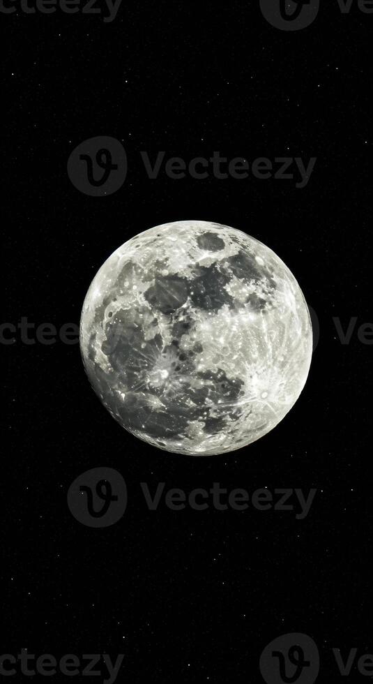 The bright and detailed full moon shines prominently in the dark expanse of space at night photo