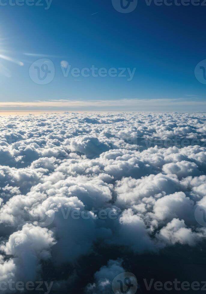 Stunning view of a vast ocean of soft, white clouds floating in the bright blue sky. photo