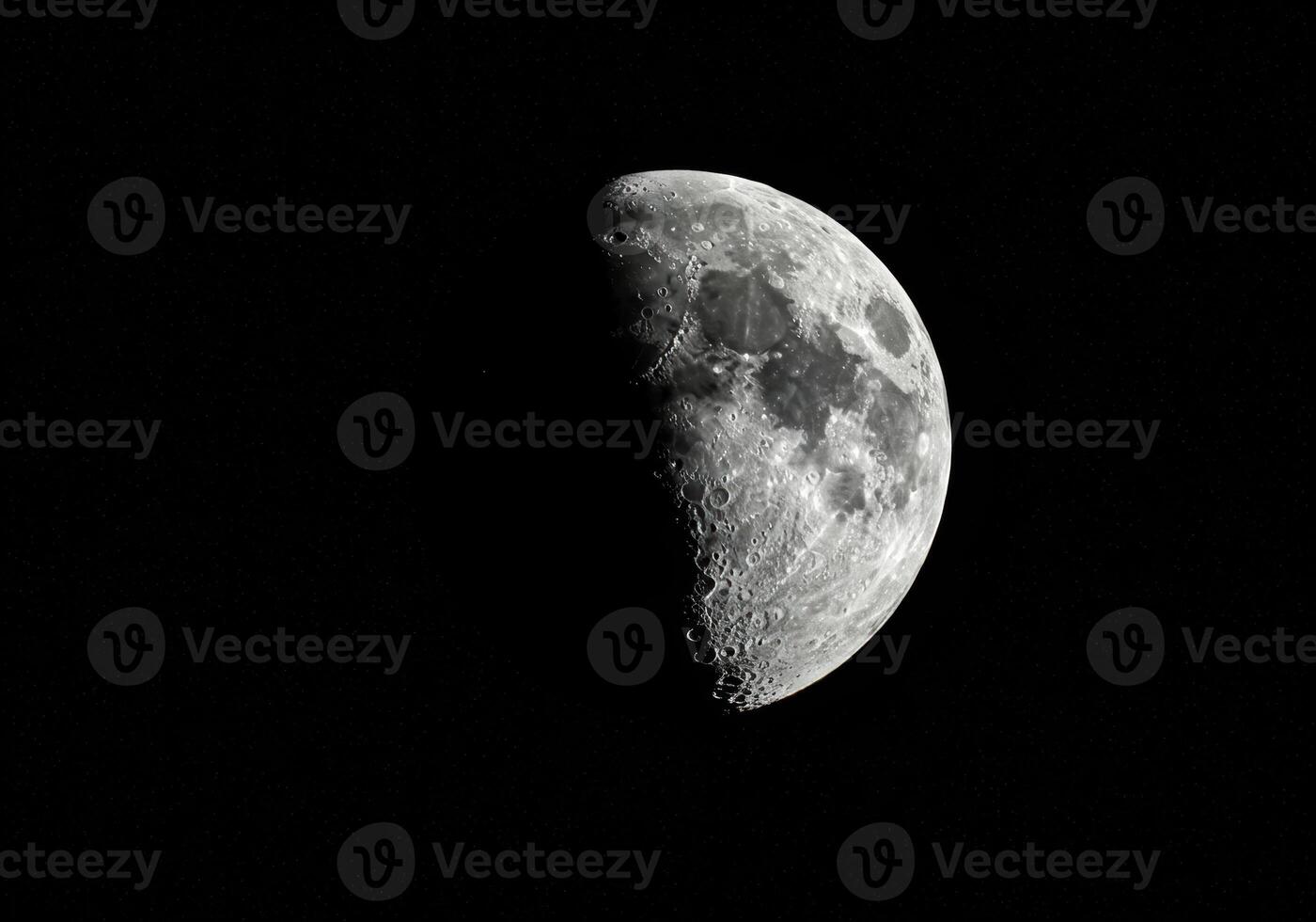 A detailed view of the moon displays its textured surface against a dark, expansive night sky. photo