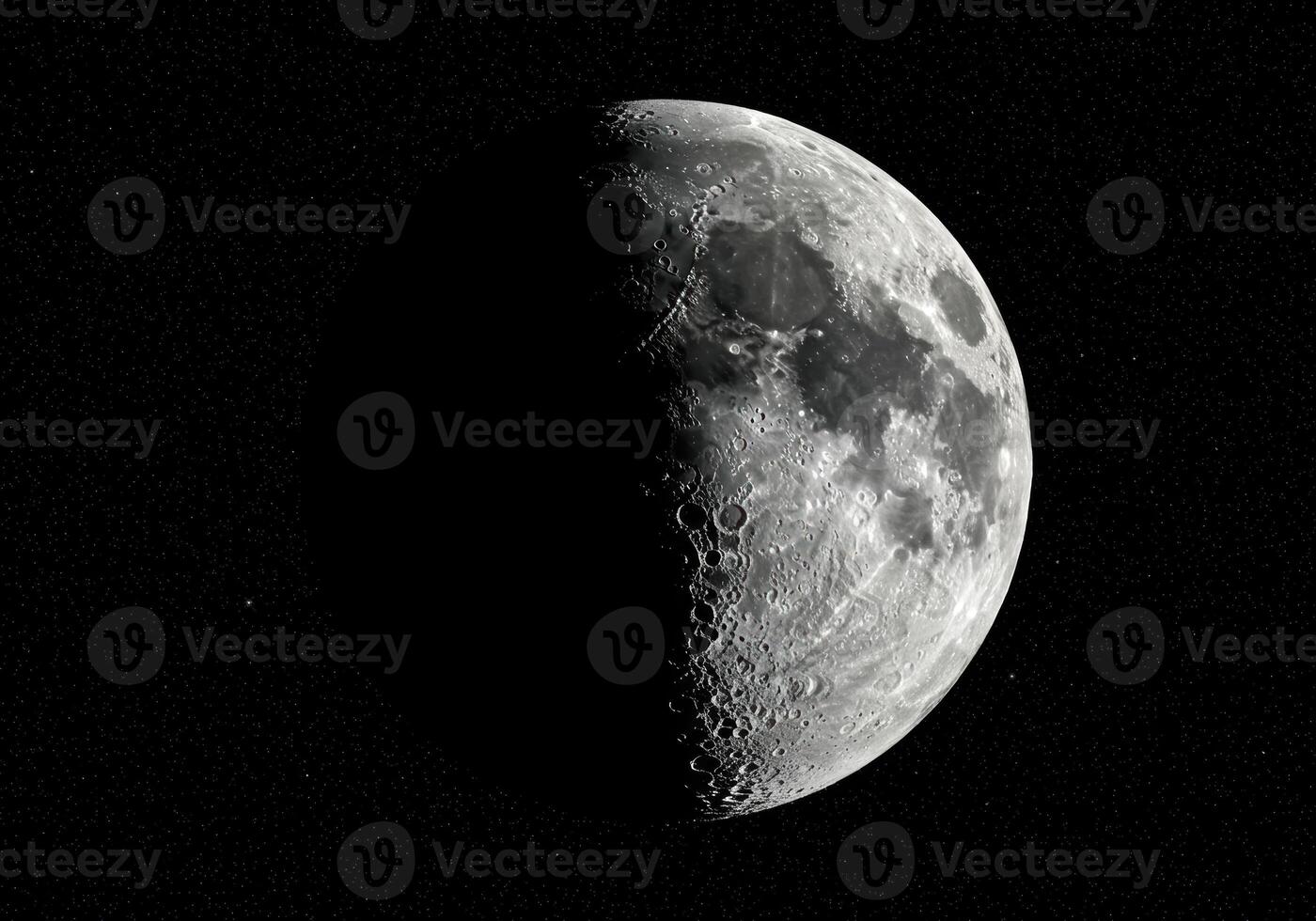 The moon in its half-illuminated phase, showing craters and details against the dark backdrop. photo