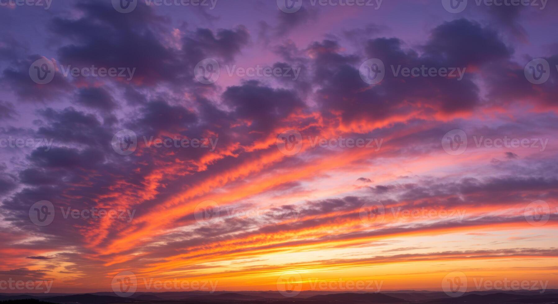 The sky is ablaze with fiery colors as the sun sets in a beautiful display of nature. photo