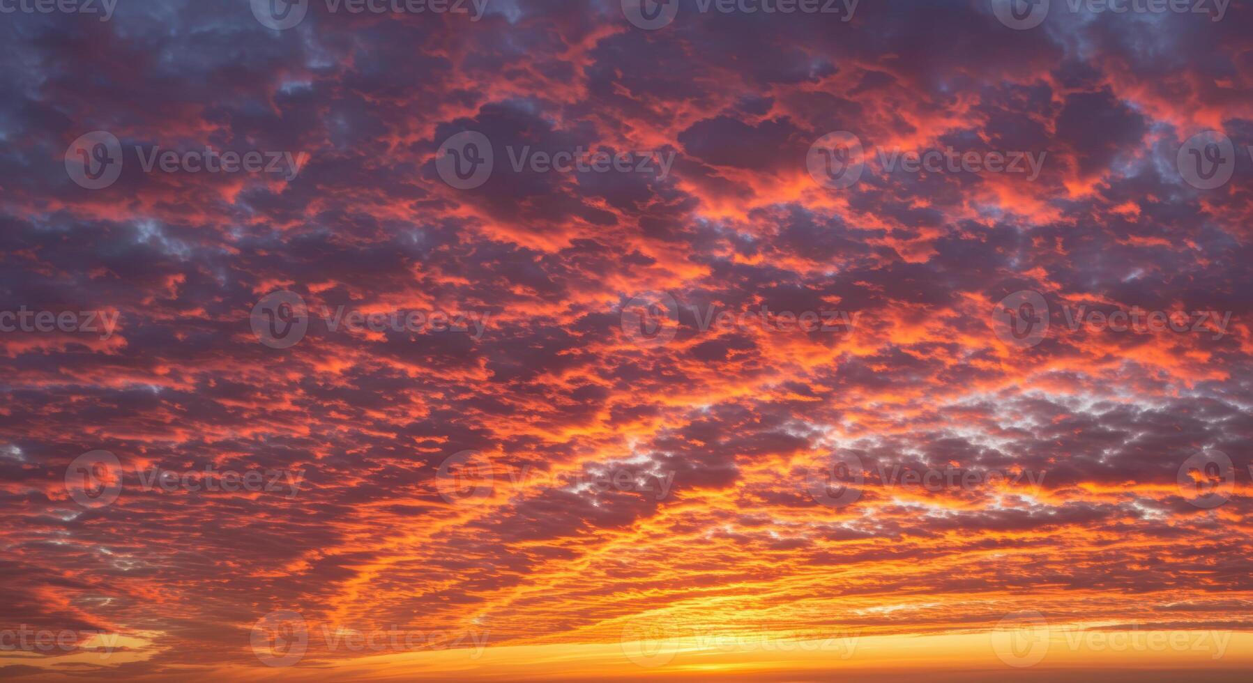 The sky displays a fiery sunset, showcasing beautiful orange and red clouds at dusk. photo