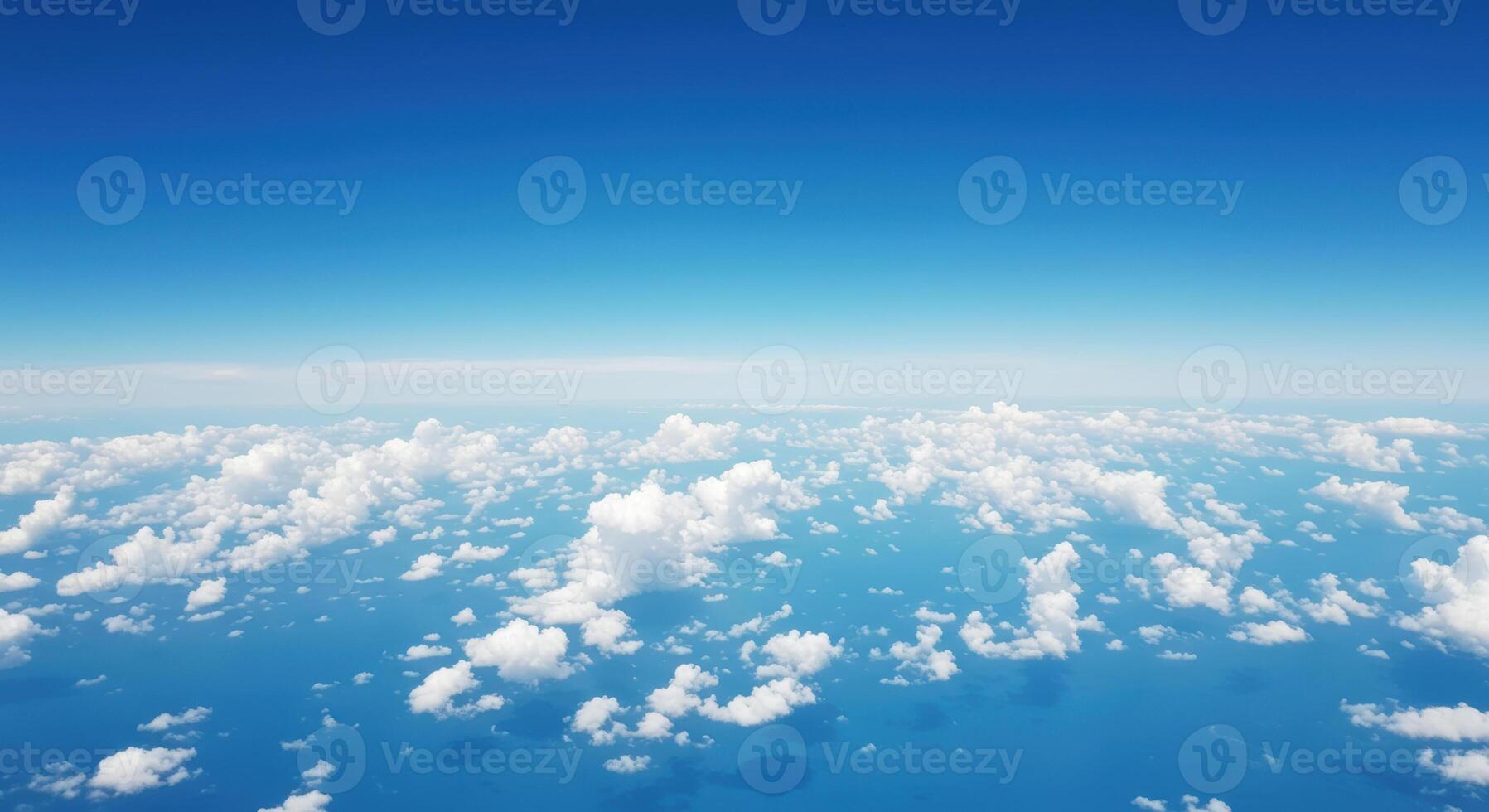A stunning view from above of a bright blue sky filled with fluffy white clouds. photo