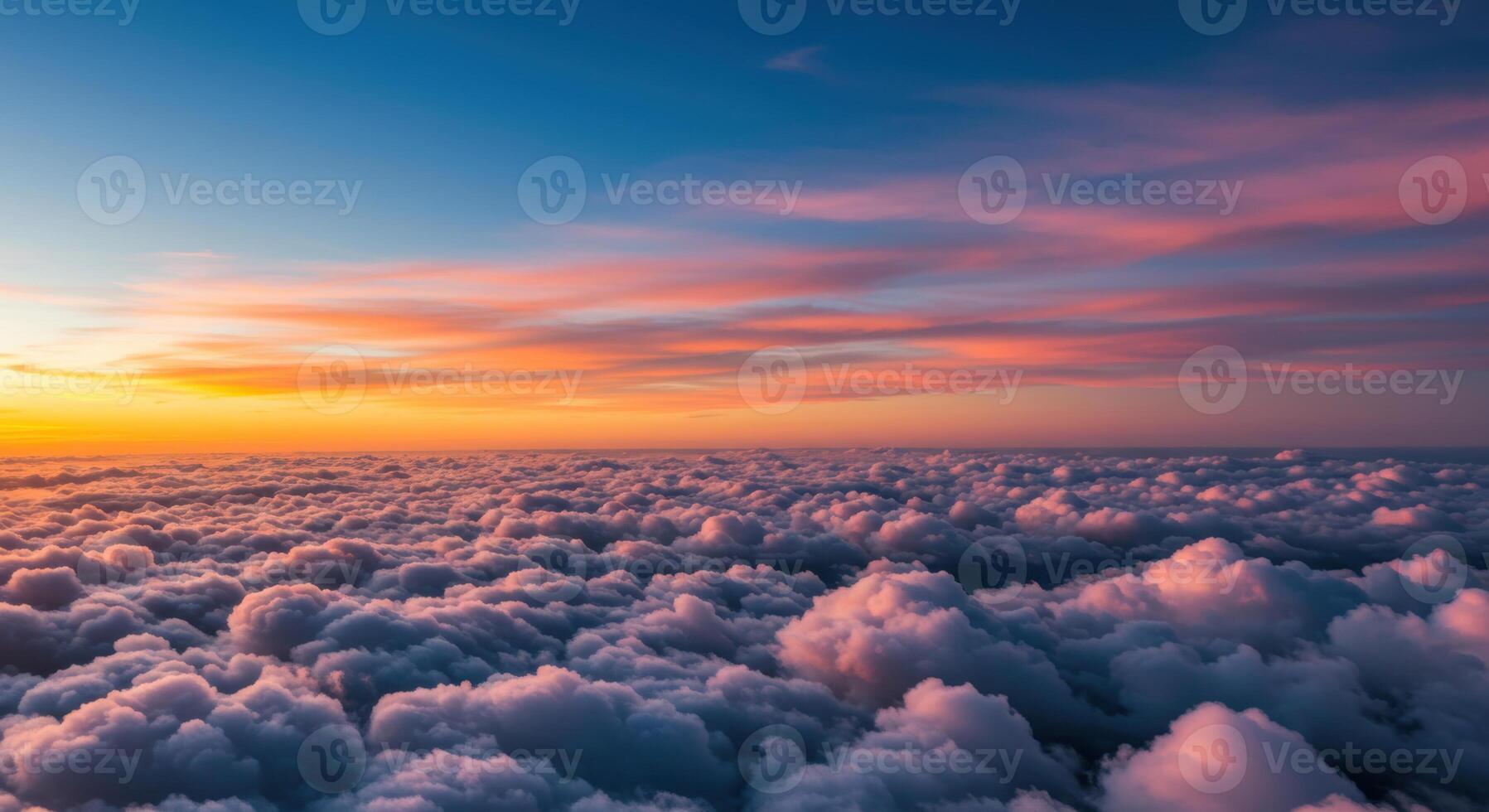 Spectacular sunrise paints the sky above a vast expanse of soft, fluffy clouds. photo