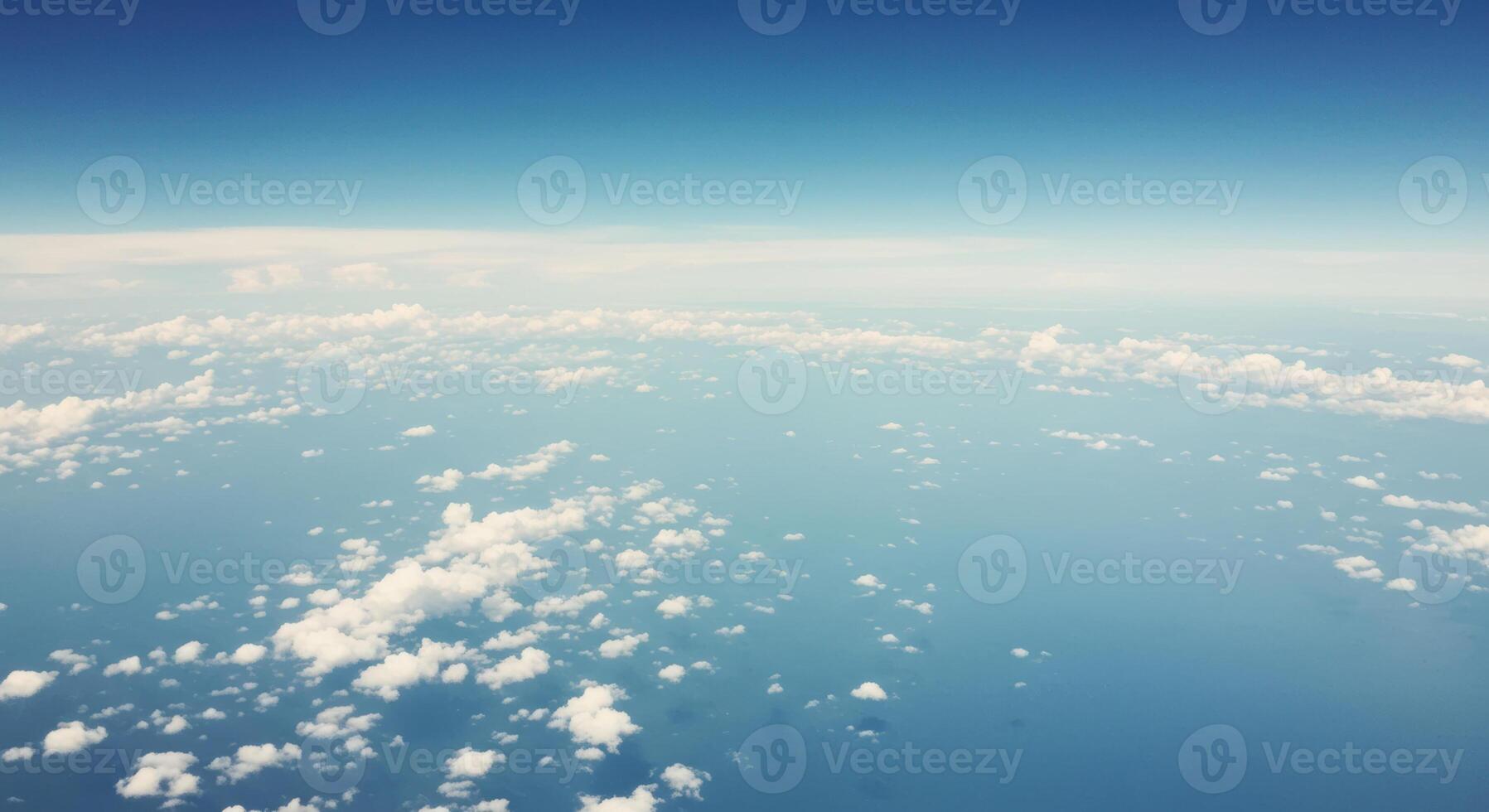 A beautiful aerial view showcasing fluffy clouds floating in a bright blue sky. photo