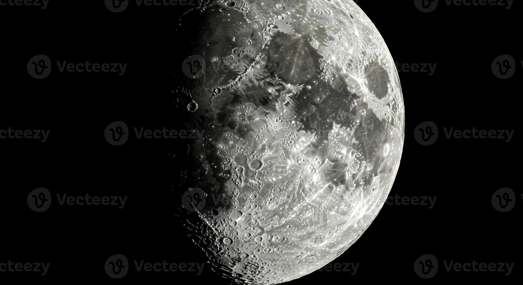 A close-up of the moon's surface showcasing detailed craters and dark areas in a dark night. photo
