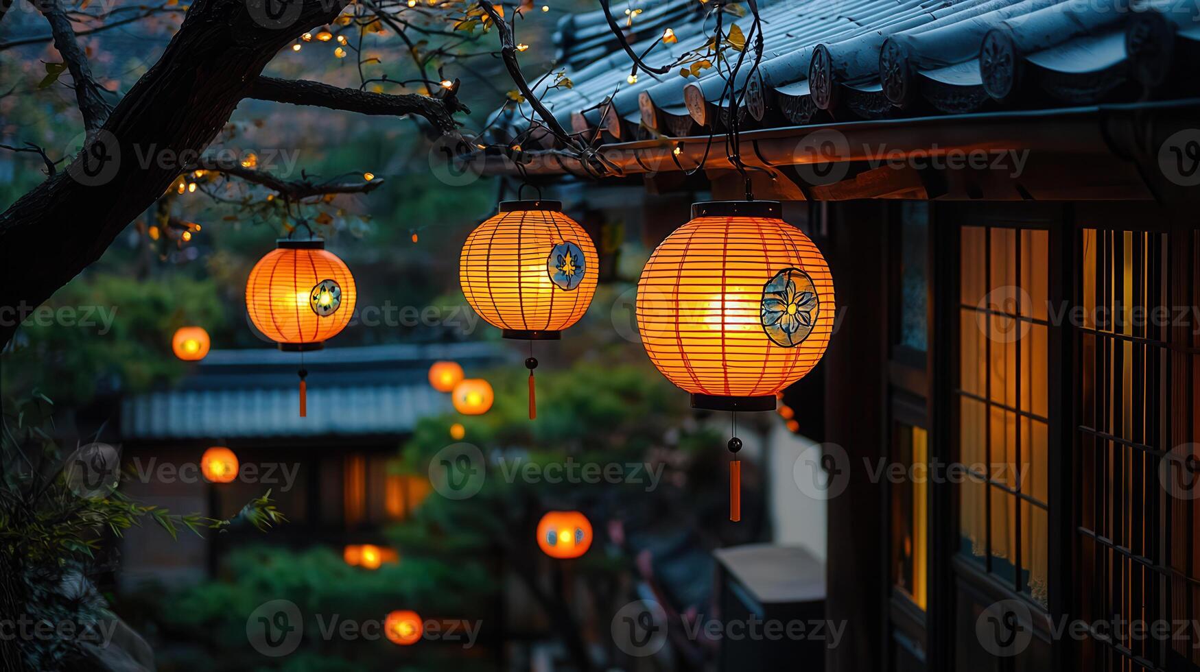 Illuminated Asian Lanterns Hanging Outdoors at Night near Traditional Houses photo