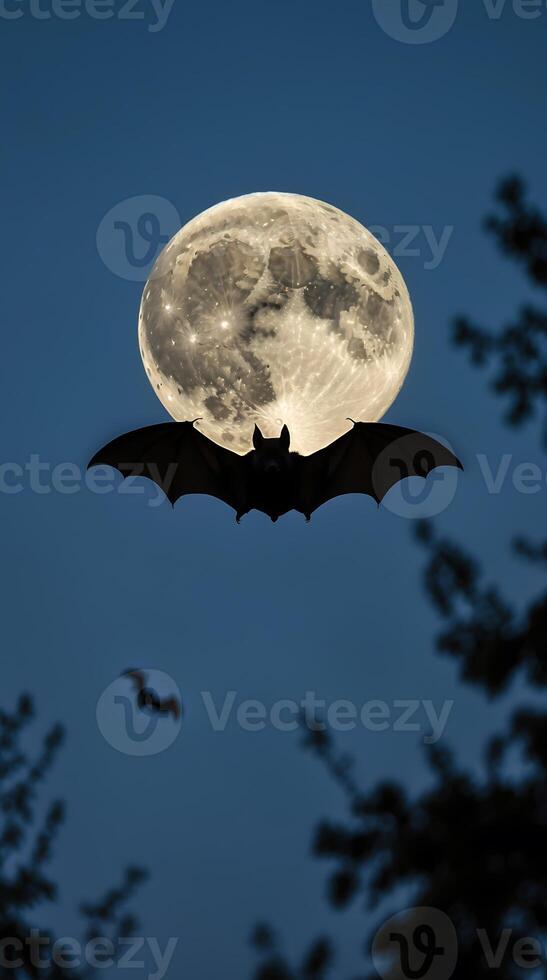 Bat gliding through twilight sky under full moon with silhouette of trees photo