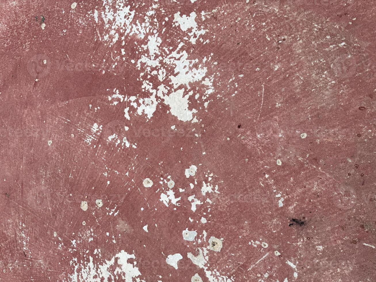 Textured surface with visible wear and paint splatter in muted colors photo