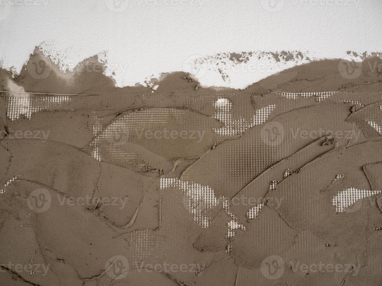 Texture of Plastering cement on a reinforcing plastic grid on a foam board photo