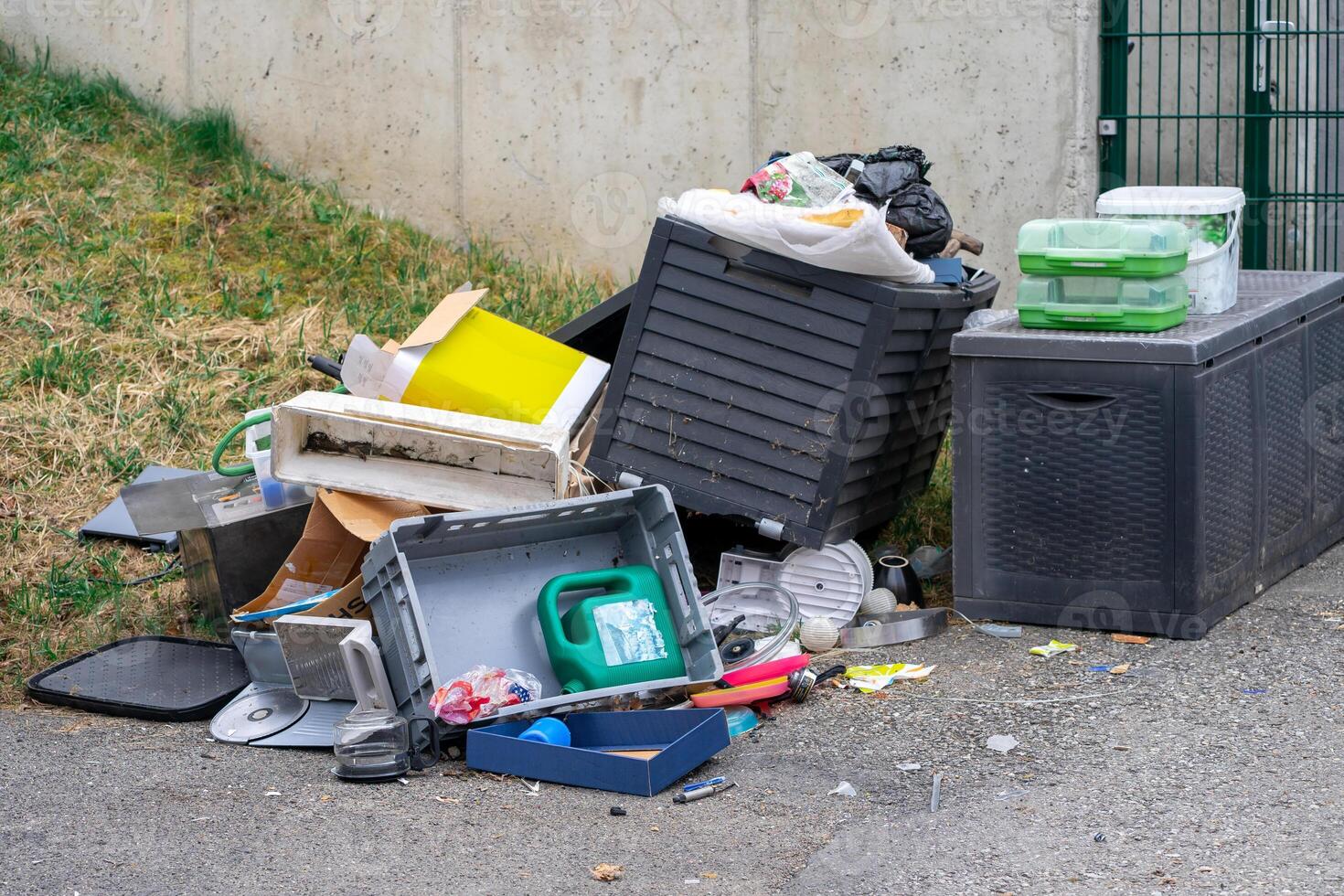 View of various discarded garbage on the street. Garbage on a city street photo