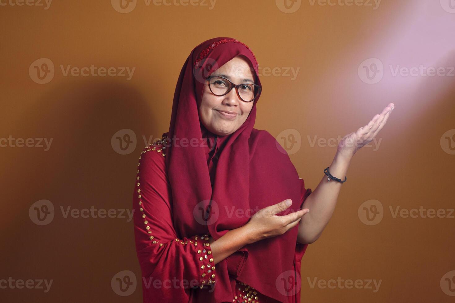Confident Muslim woman presenting an empty space for product placement photo