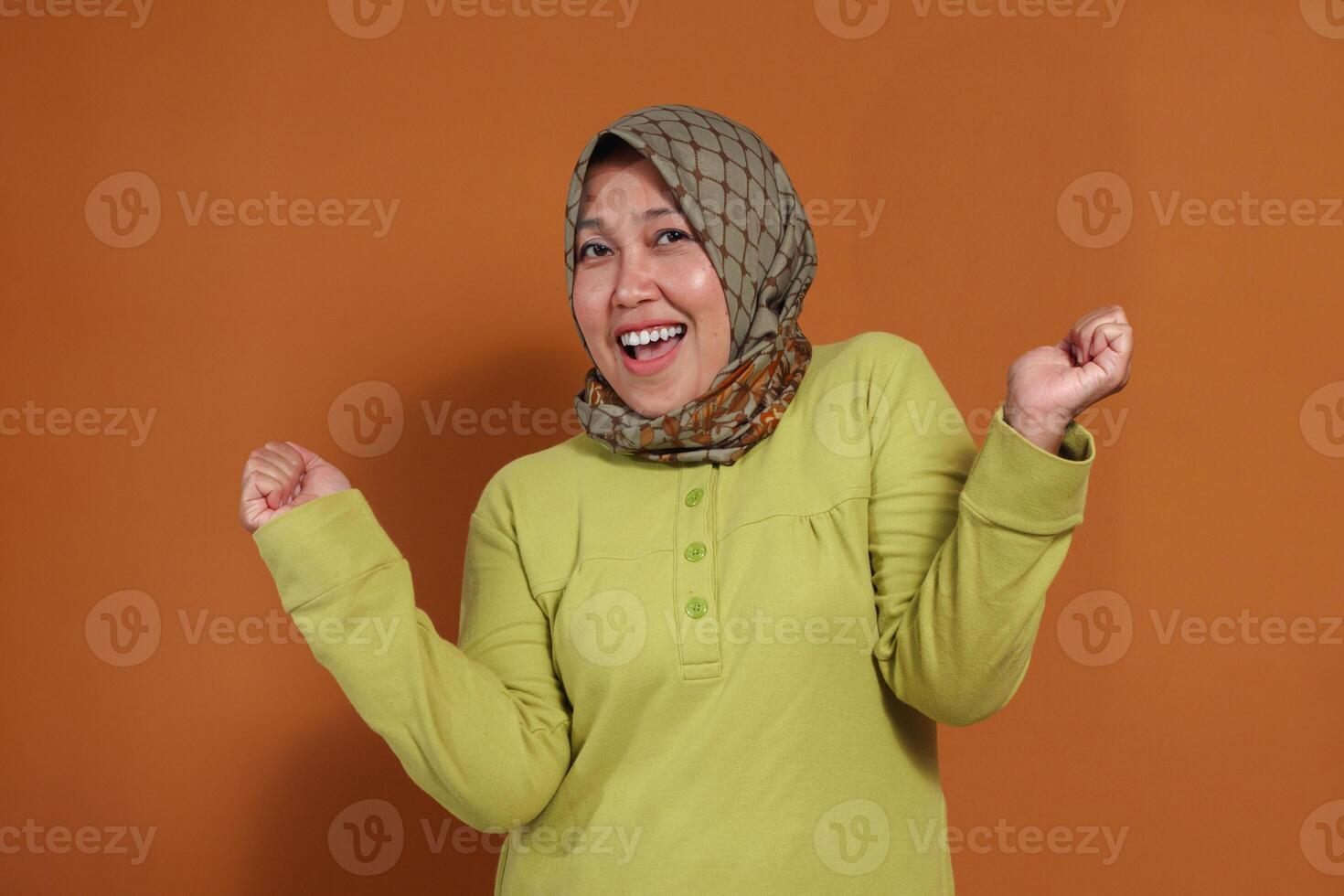 Excited woman celebrating joyful success with expressive pose, perfect for concepts of achievement, happiness, motivation, and positive emotions in business or lifestyle themes photo