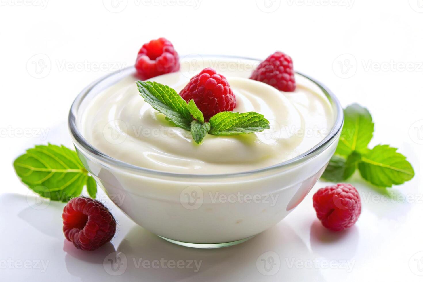 smooth and creamy yogurt bowl with fresh raspberries, blueberries, and mint leaves, set against a white background photo