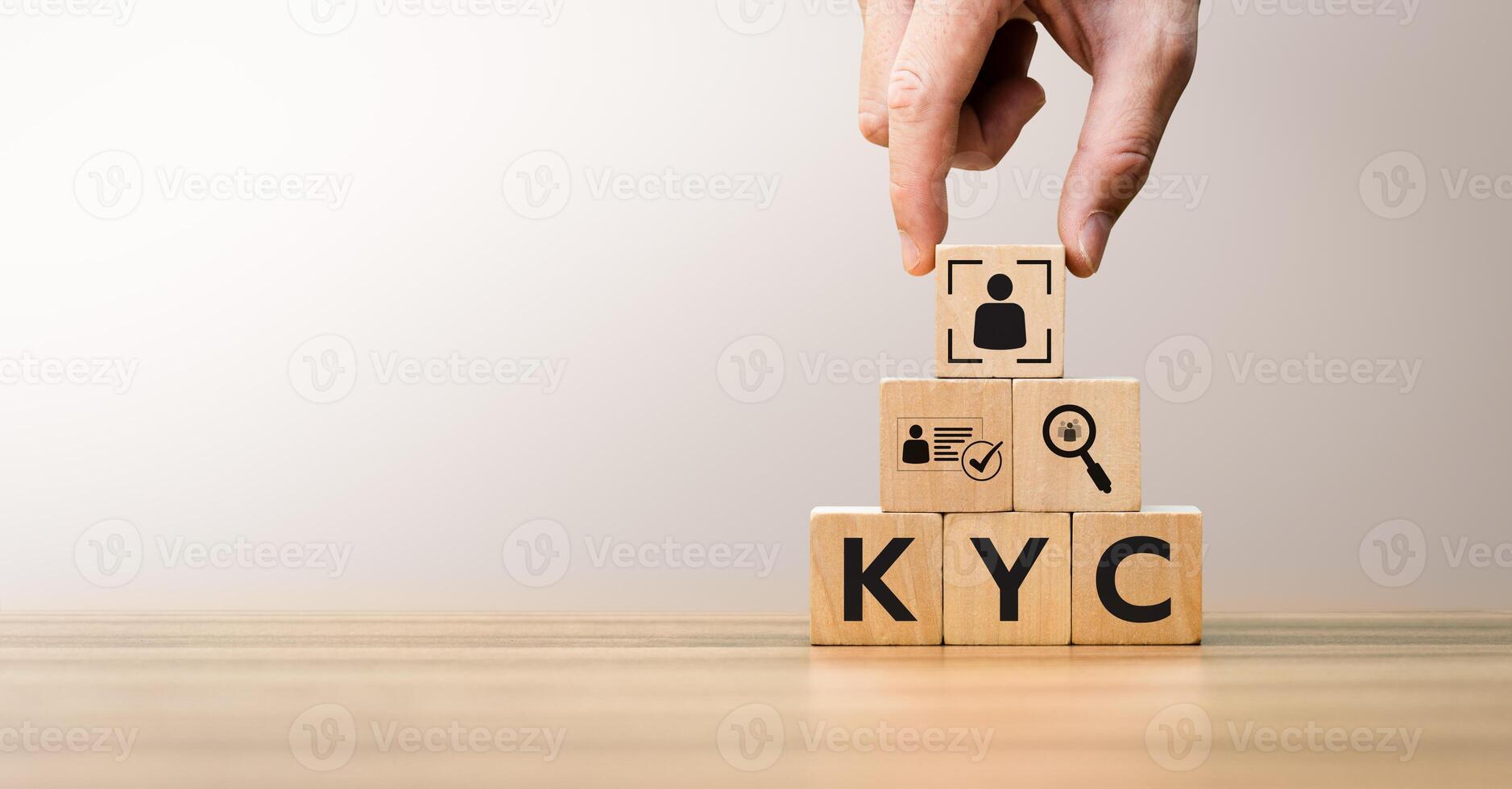 Hand arranging wooden blocks with KYC icons, representing Know Your Customer process, digital identity verification, compliance, anti-fraud measures, and customer authentication concepts. photo