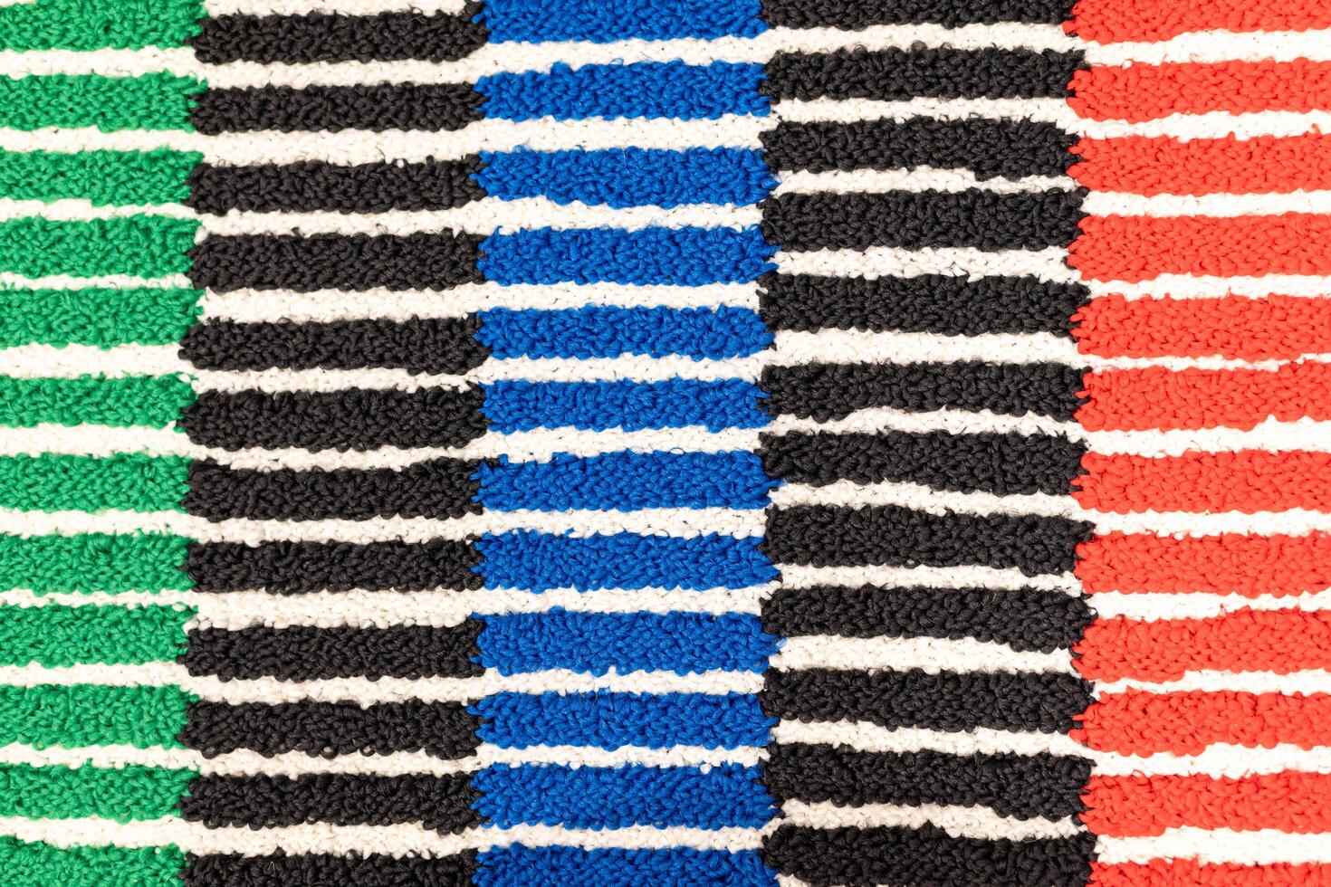 Colorful Woven Fabric with Bold Striped Pattern. textured woven fabric featuring a symmetrical striped pattern. photo