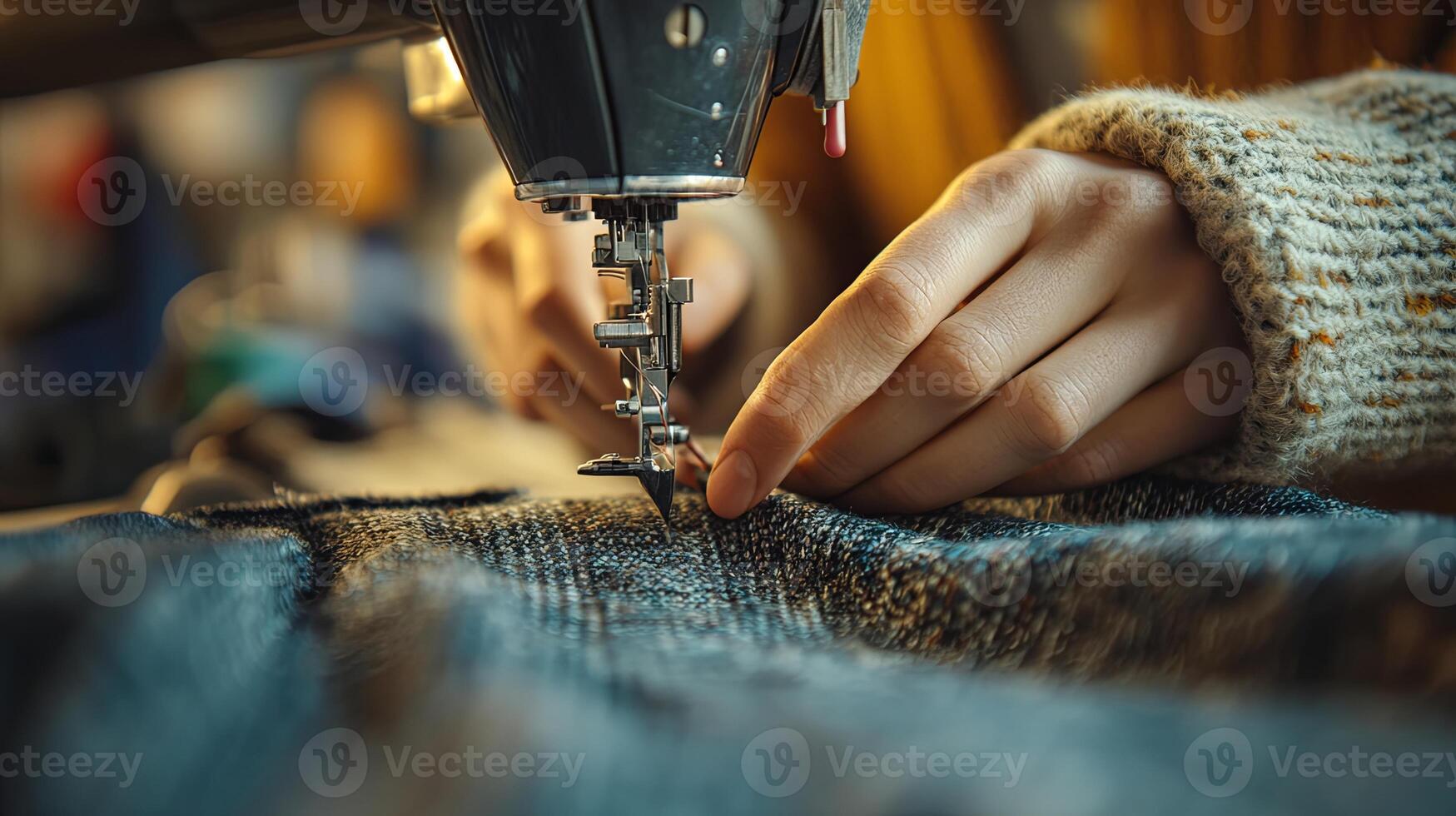 Expert hands skillfully sewing fabric with precision for a beautifully finished textile project in a cozy workspace setting during daylight hours photo