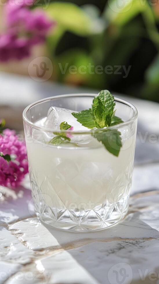 An elegant milk-based cocktail served in a crystal glass and garnished with mint, representing dairy celebration and gourmet drinks. photo