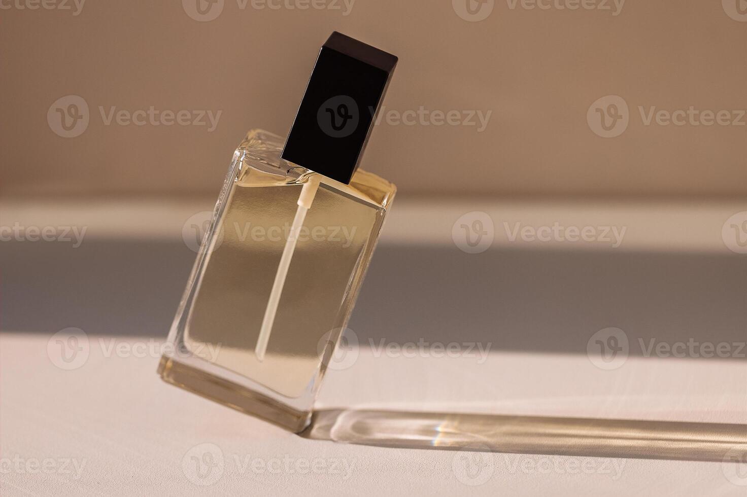Close-up of a transparent glass elegant perfume bottle with a black lid photo