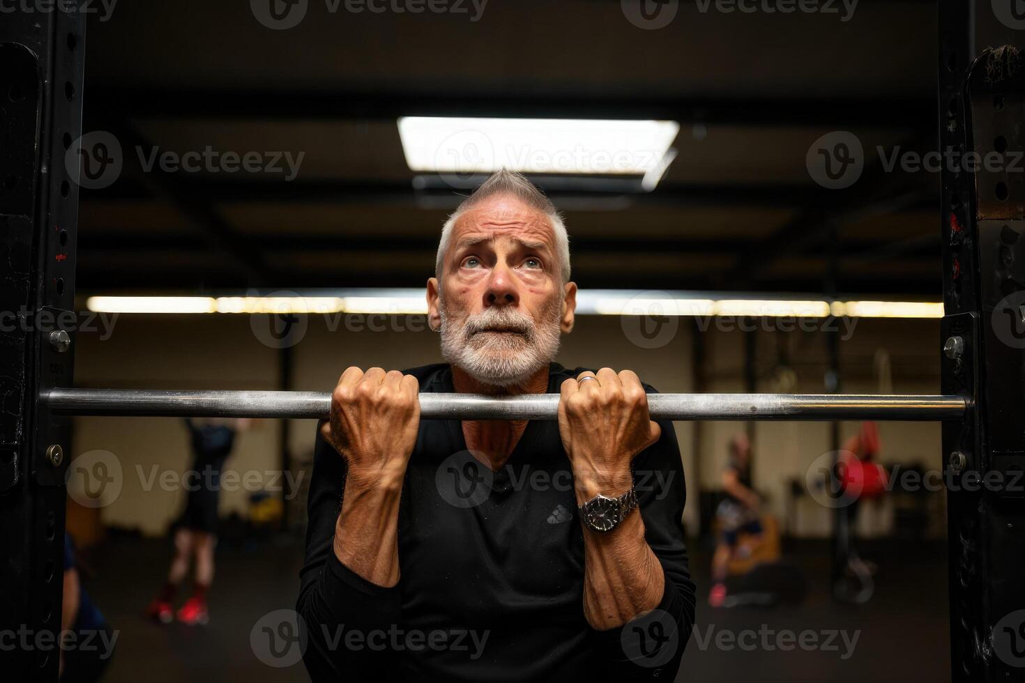 An elderly man is preparing to do pull-ups at the gym, showing strength and determination in his fitness journey. photo