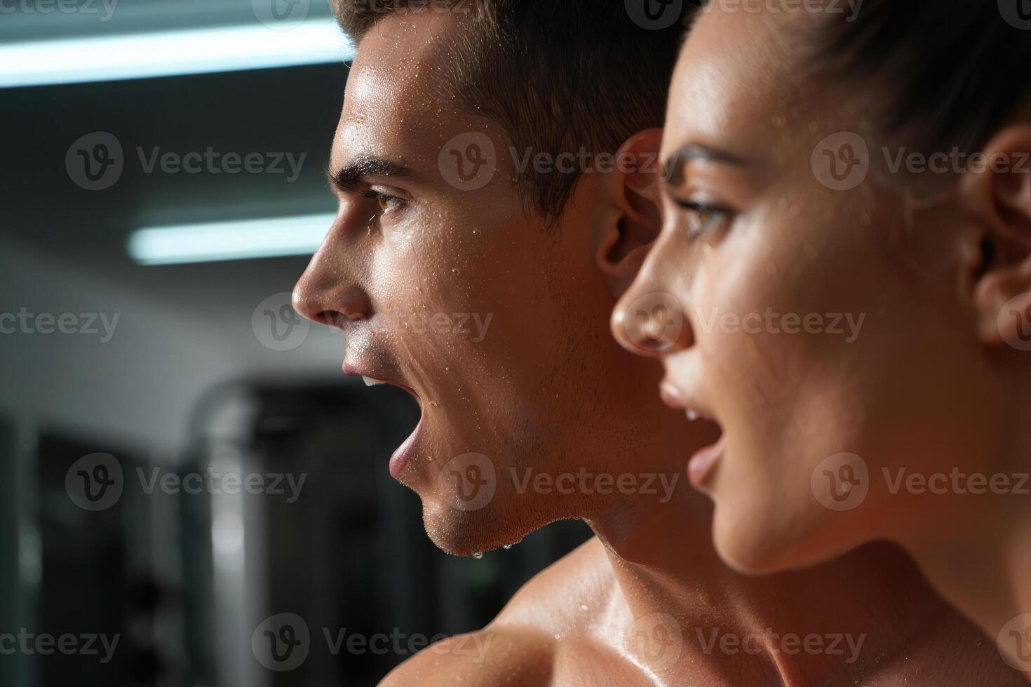 A fit couple catches their breath, glistening with sweat after a challenging workout session. photo