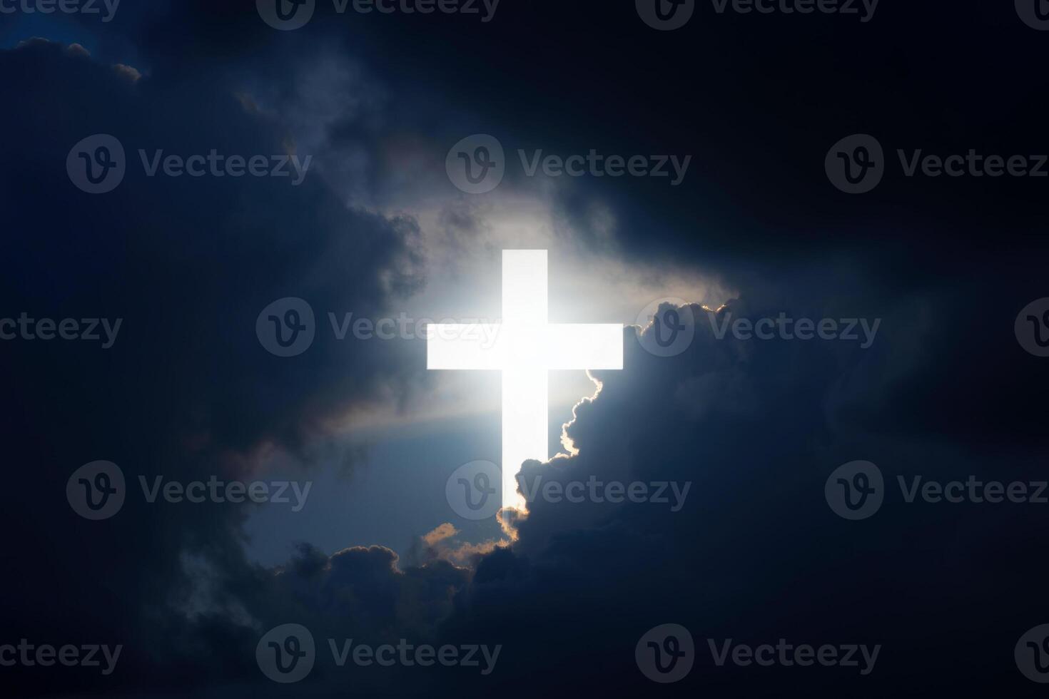 Bright cross emerges from dark clouds against a dramatic sunset sky symbolizing hope and faith photo