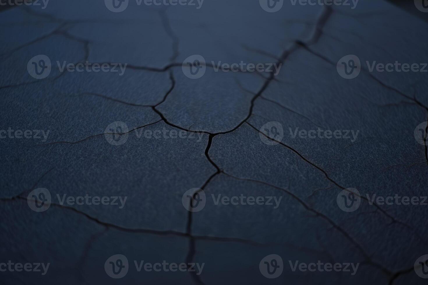 A close-up view reveals a textured surface with intricate cracks, forming an abstract design. photo
