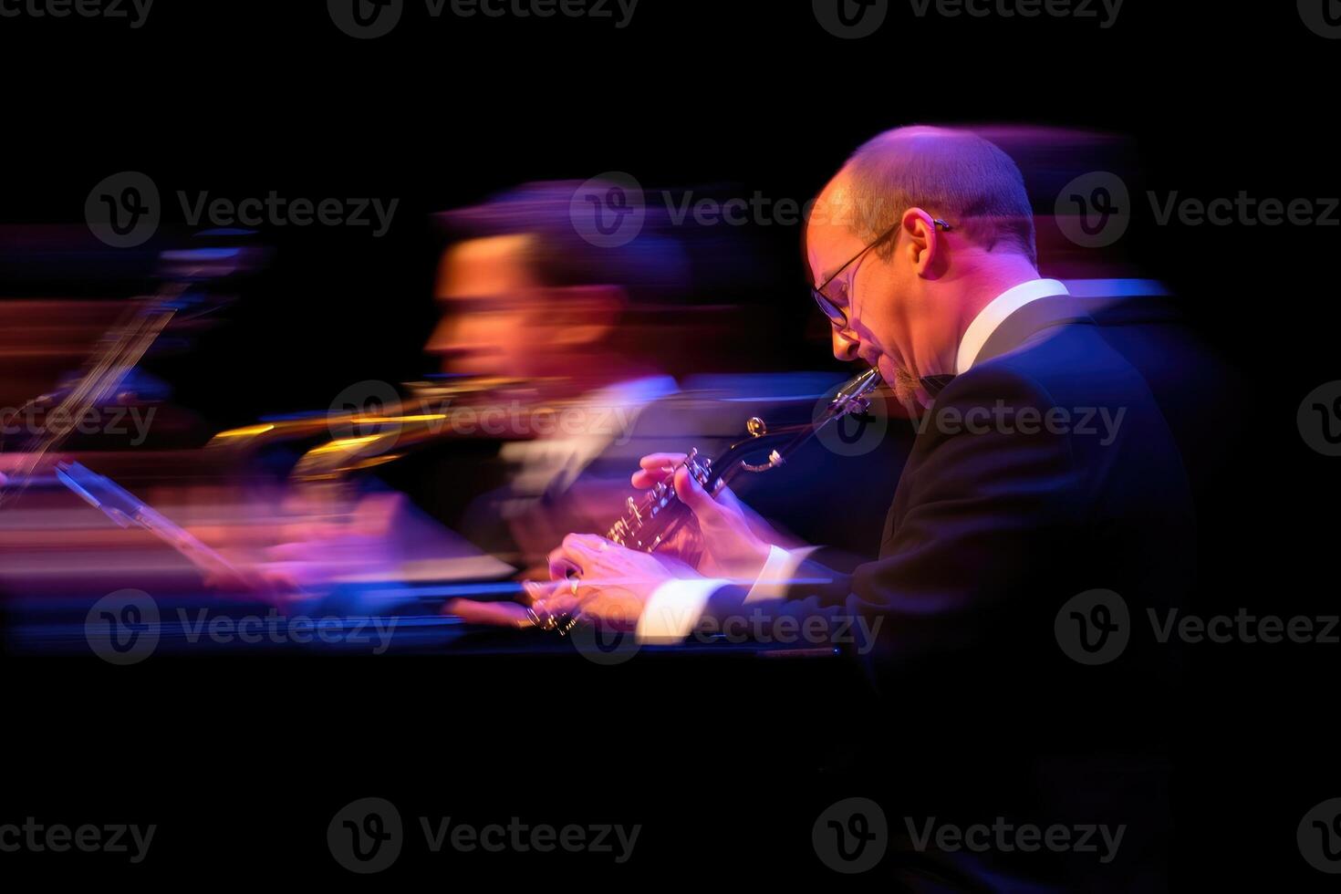 Musician performs passionately on stage during an evening concert in a vibrant atmosphere photo