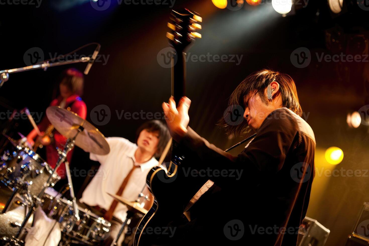 Energetic live band performance in a vibrant music venue at night photo