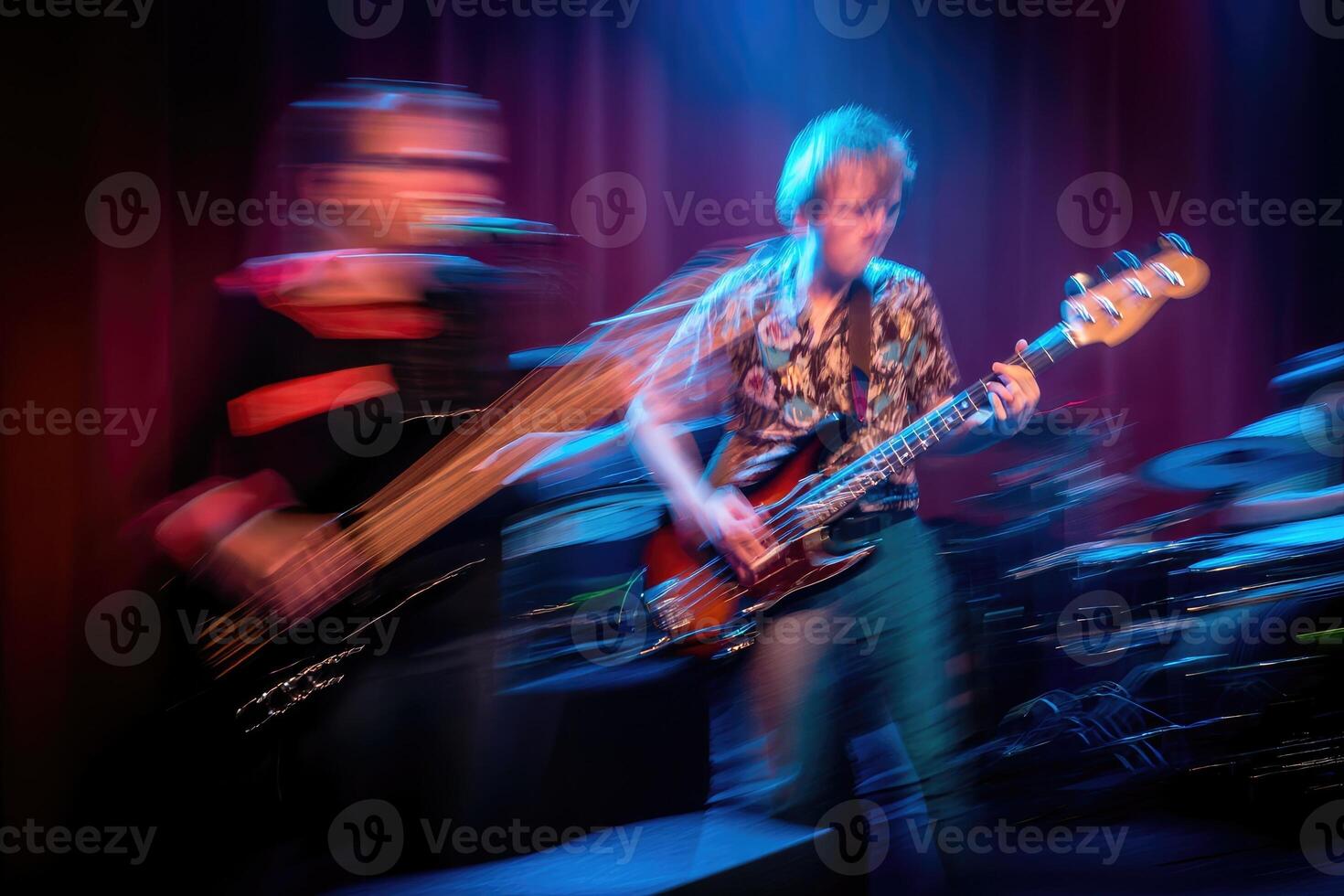 Dynamic band performing energetic live music in a vibrant venue at night photo