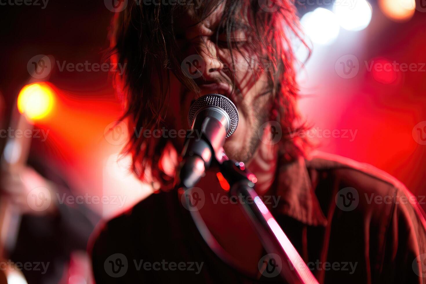 Dynamic performance by a musician on stage during a live concert in an energetic venue setting photo