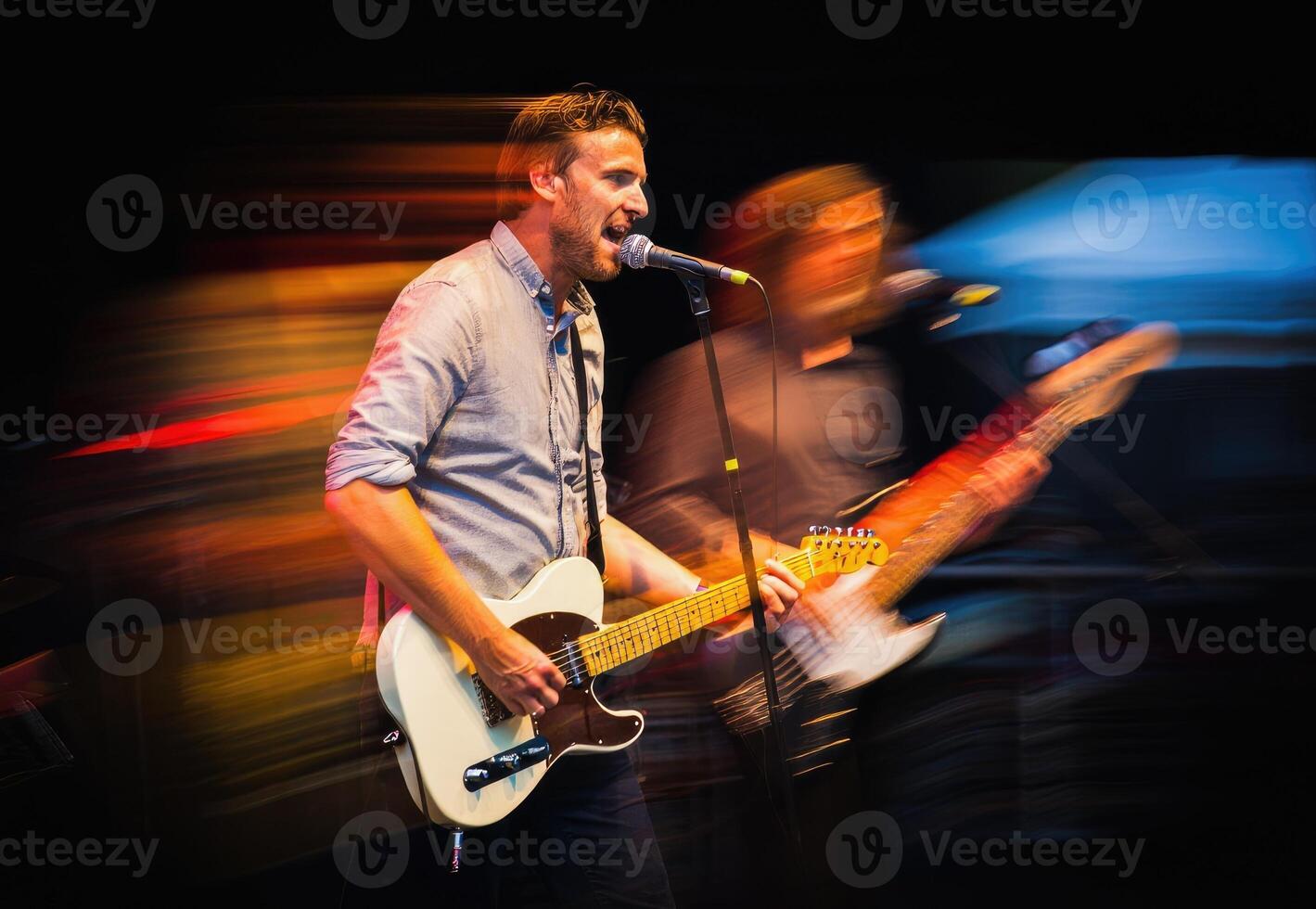 Live music performance with guitarist and vocalist engaging the audience at a night event photo
