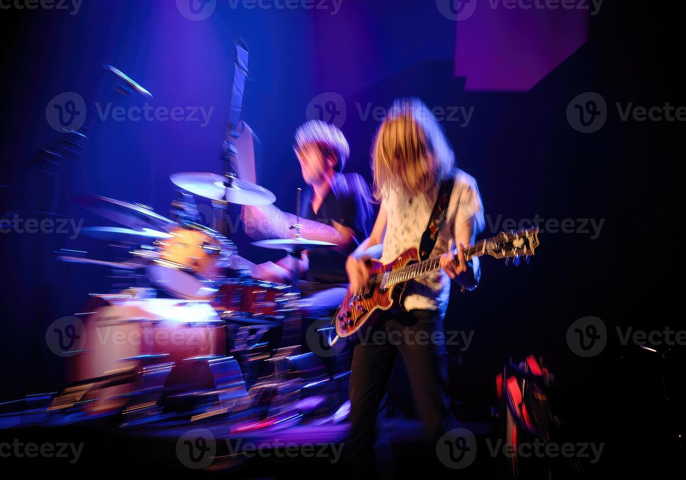Musicians perform live on stage during an electrifying concert in a vibrant venue photo