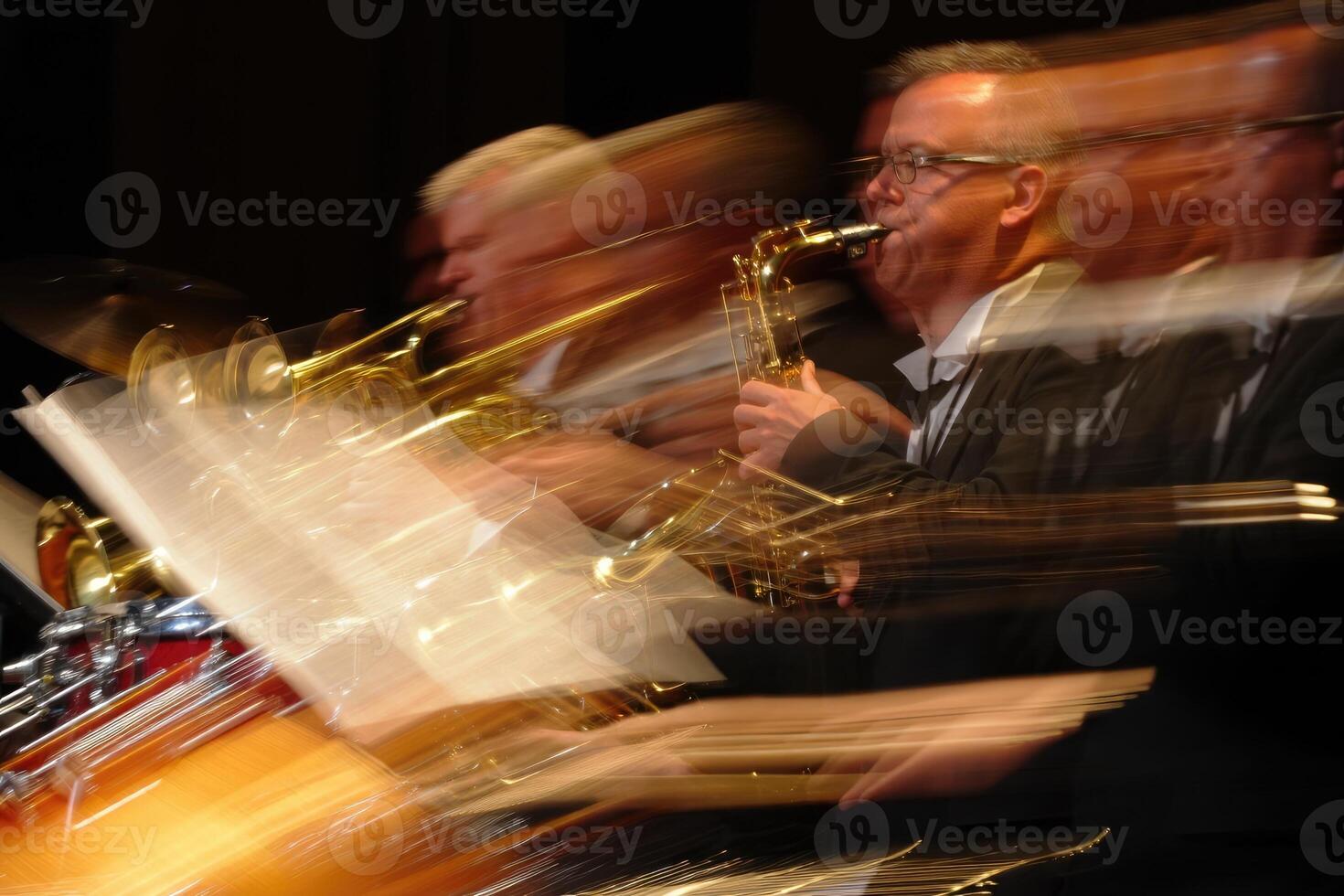 Musicians performing energetically on stage during a lively jazz concert at night photo