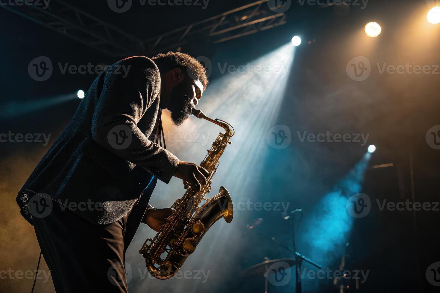 Musician plays saxophone during live performance at night event with dramatic lighting effects photo