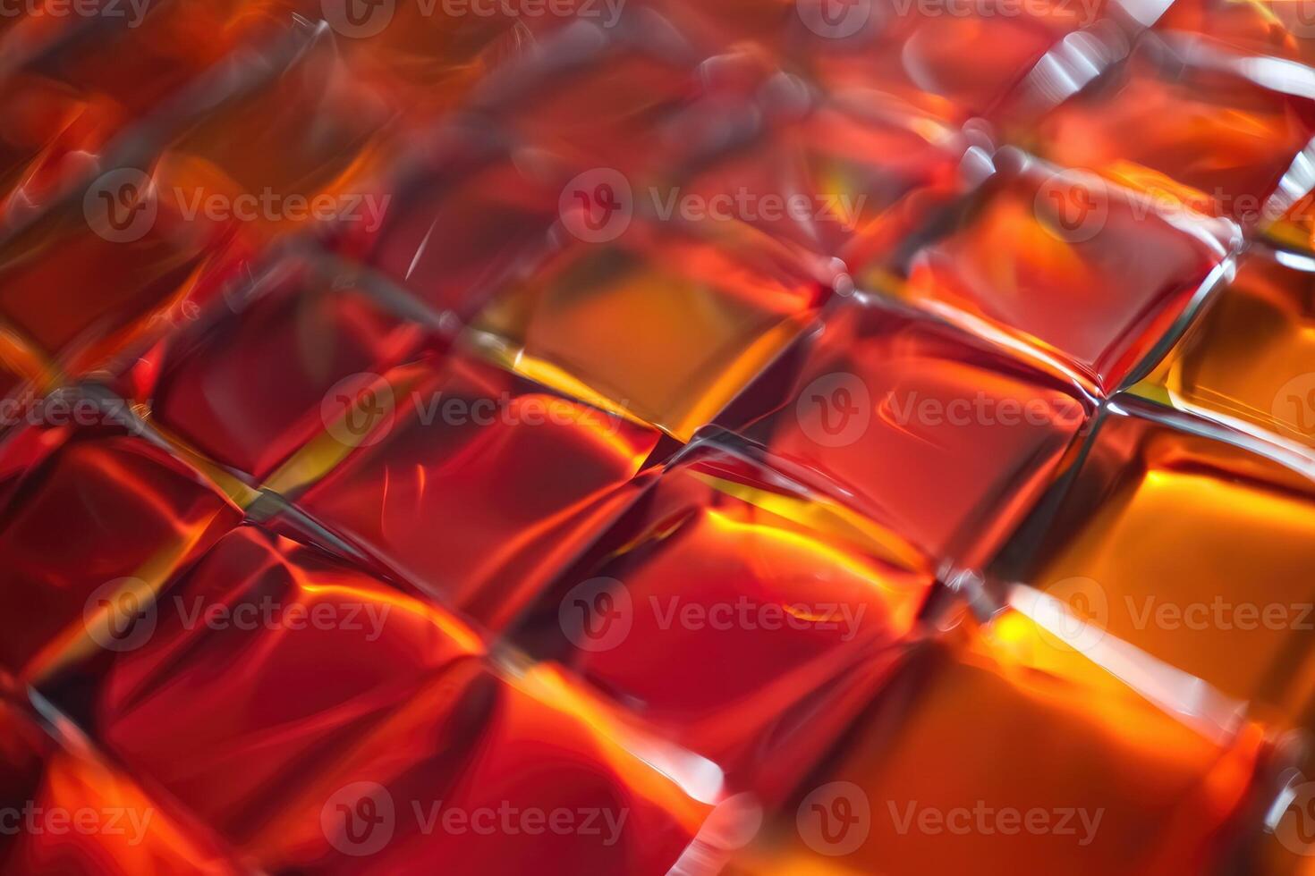 Colorful textured surface featuring glossy red and orange squares reflecting light at close range photo