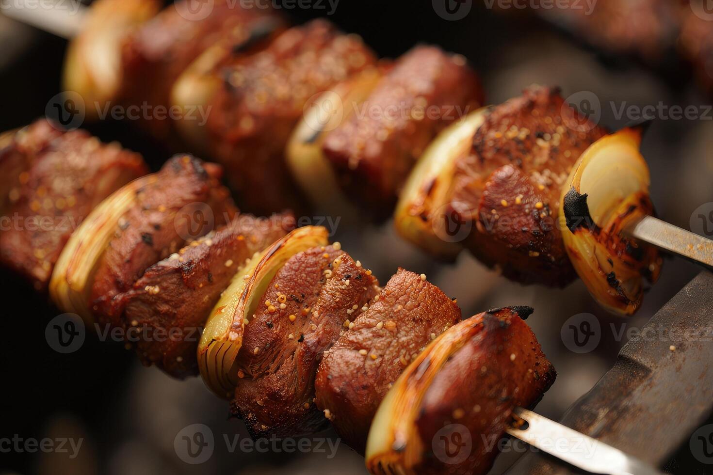 Grilled beef skewers with onions over charcoal in a backyard barbecue setting photo