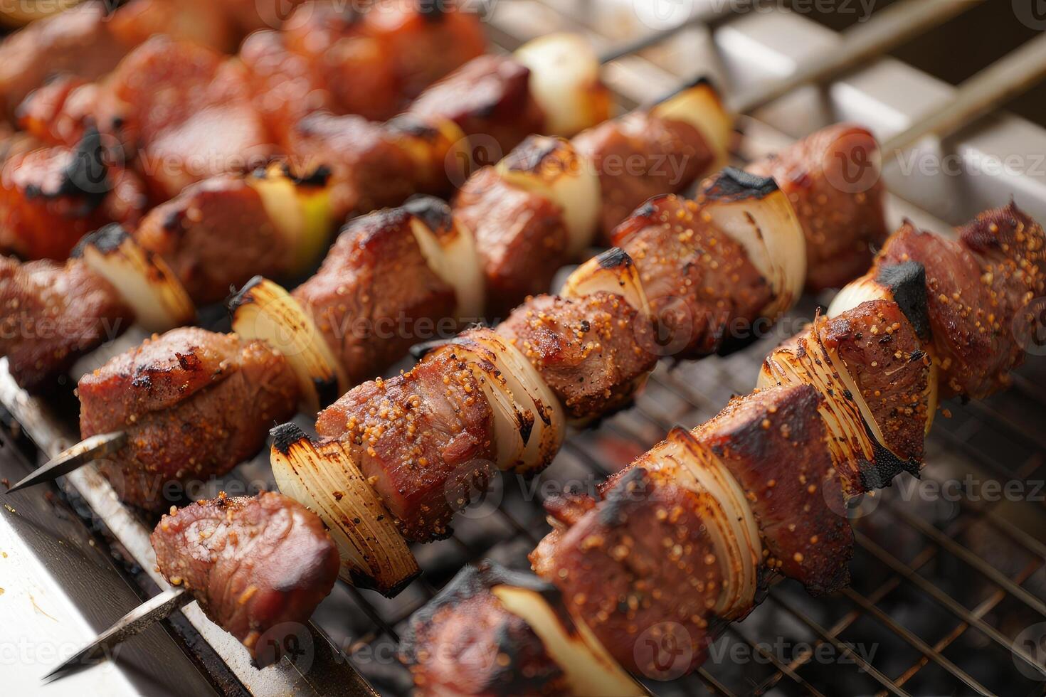 Grilling skewers of meat and vegetables on a barbecue at a summer gathering photo