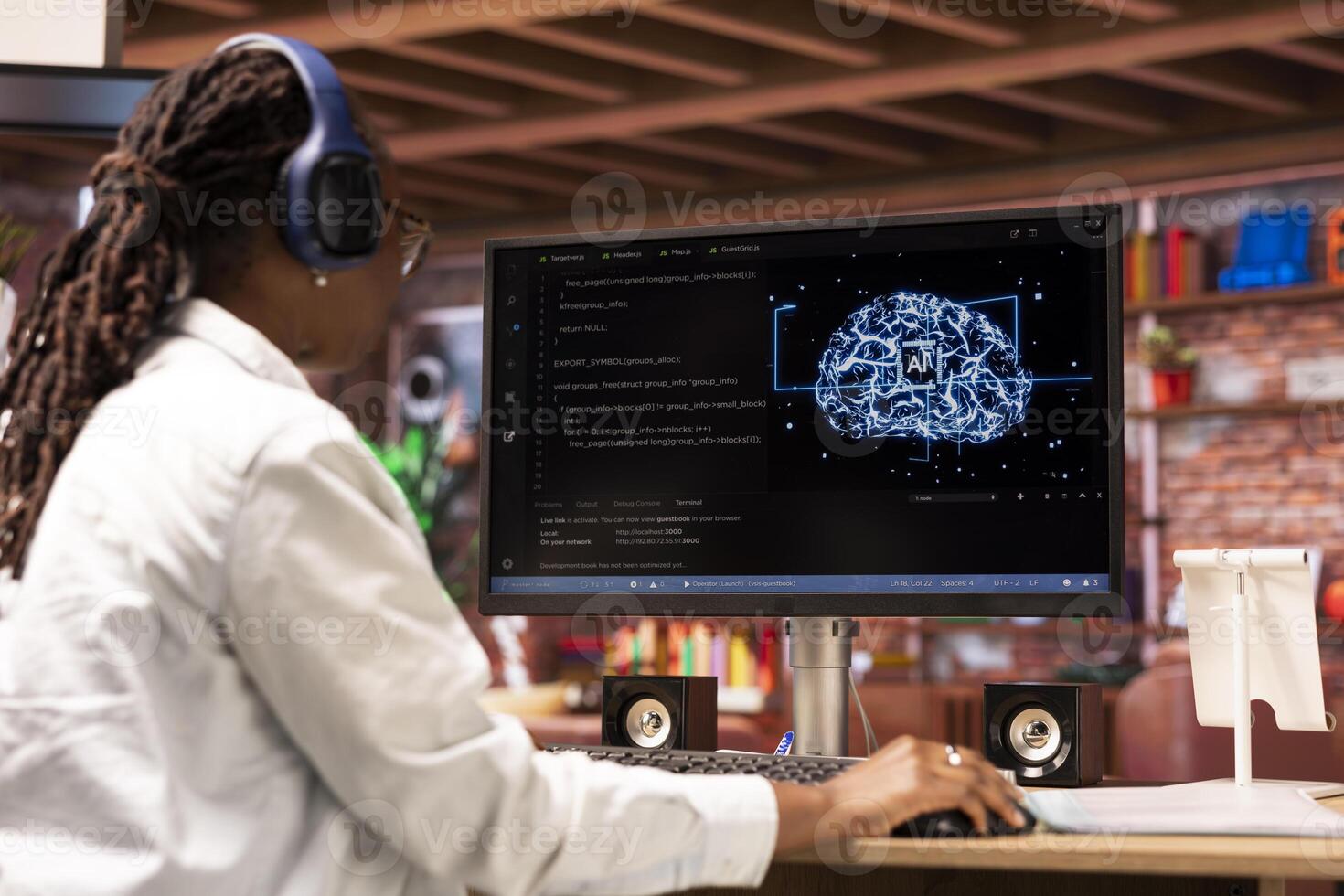 Admin writing code on computer and doing maintenance on artificial intelligence neural networks, listening music. Tech support expert wearing headphones typing on keyboard, doing checkup on AI systems photo