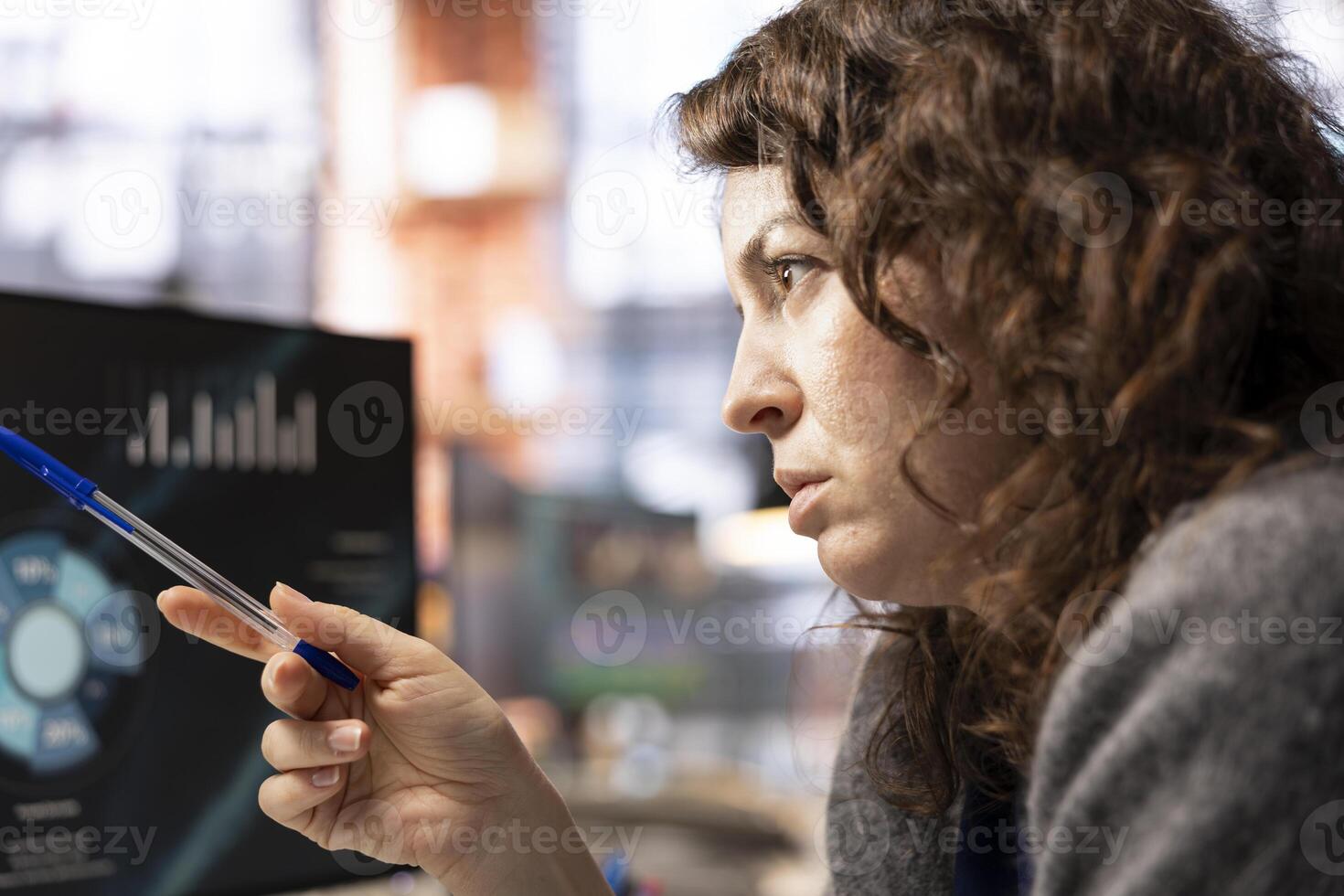 Student doing online learning for career business development, taking notes while watching presentation. Woman gathering information from internet seminar on computer display. photo