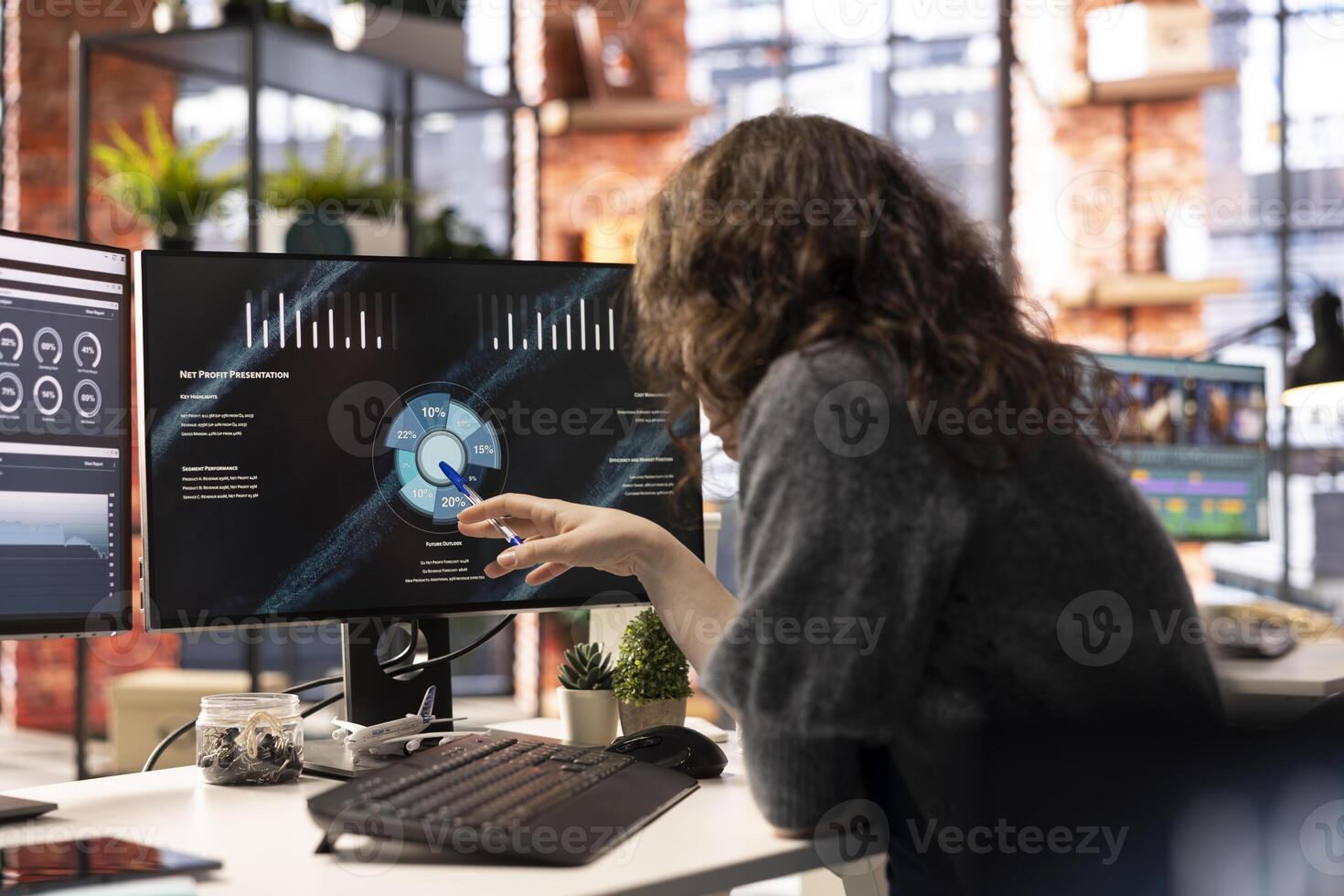 Female analyst looking at presentation charts and dashboard to implement analytics tools for the business, monitoring statistics. Businesswoman reviews performance metrics diagrams. photo