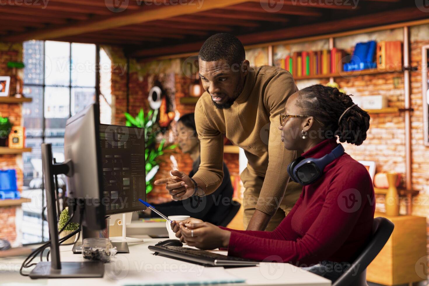 Teamworking startups employees leveraging machine learning technology in office to gain competitive edge. Silicon Valley company colleagues collaborating to do rapid technological advancement photo