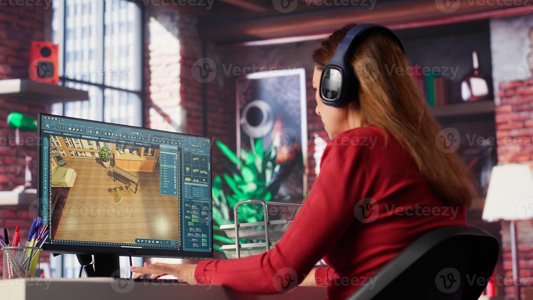 Woman at home creating a 3D render of an apartment interior layout, utilizing architectural software. Developer uses digital tools to decorate detailed home design, placing assets. Camera A. photo