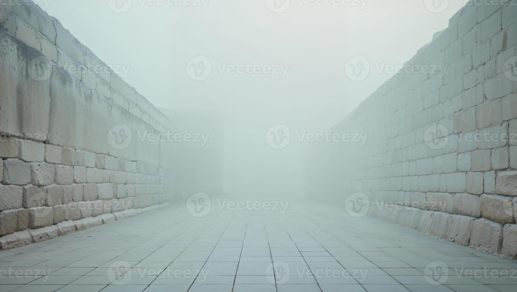 An empty stone wall is seen in the fog photo