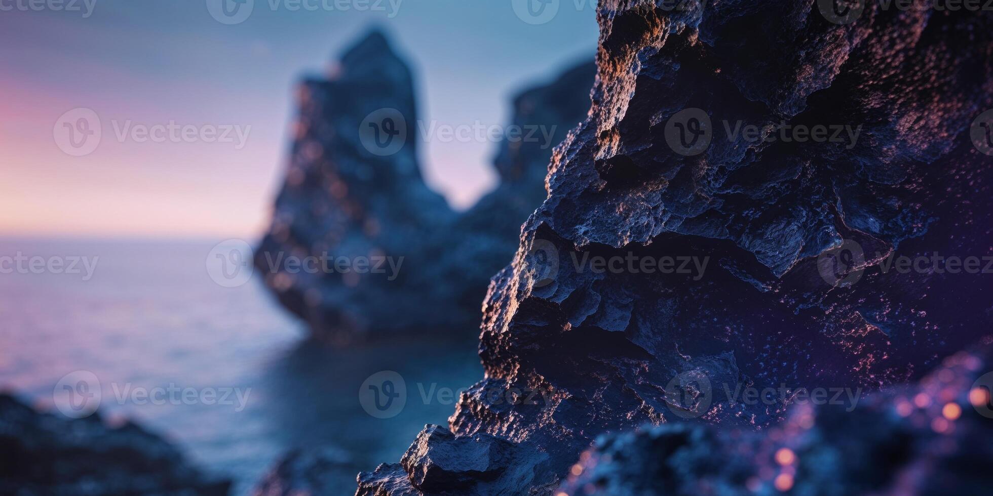 A rock formation in the ocean at sunset photo