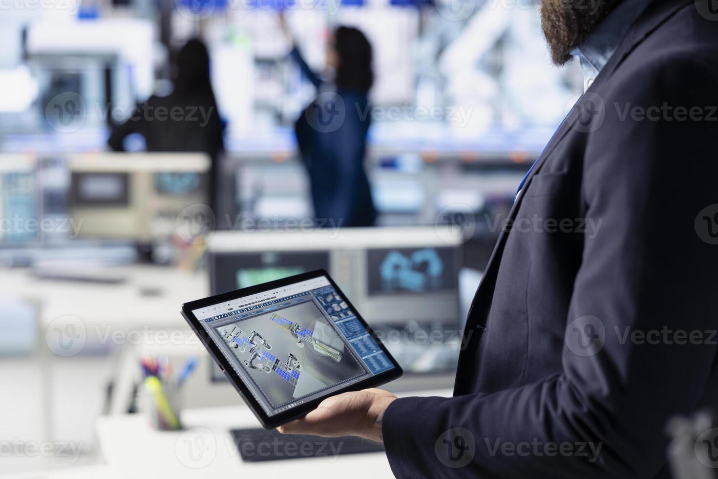 Photovoltaics factory technician creating CAD technical drawings for solar modules using tablet. Employee developing solar panel designs on device for efficiency and manufacturability, closeup photo