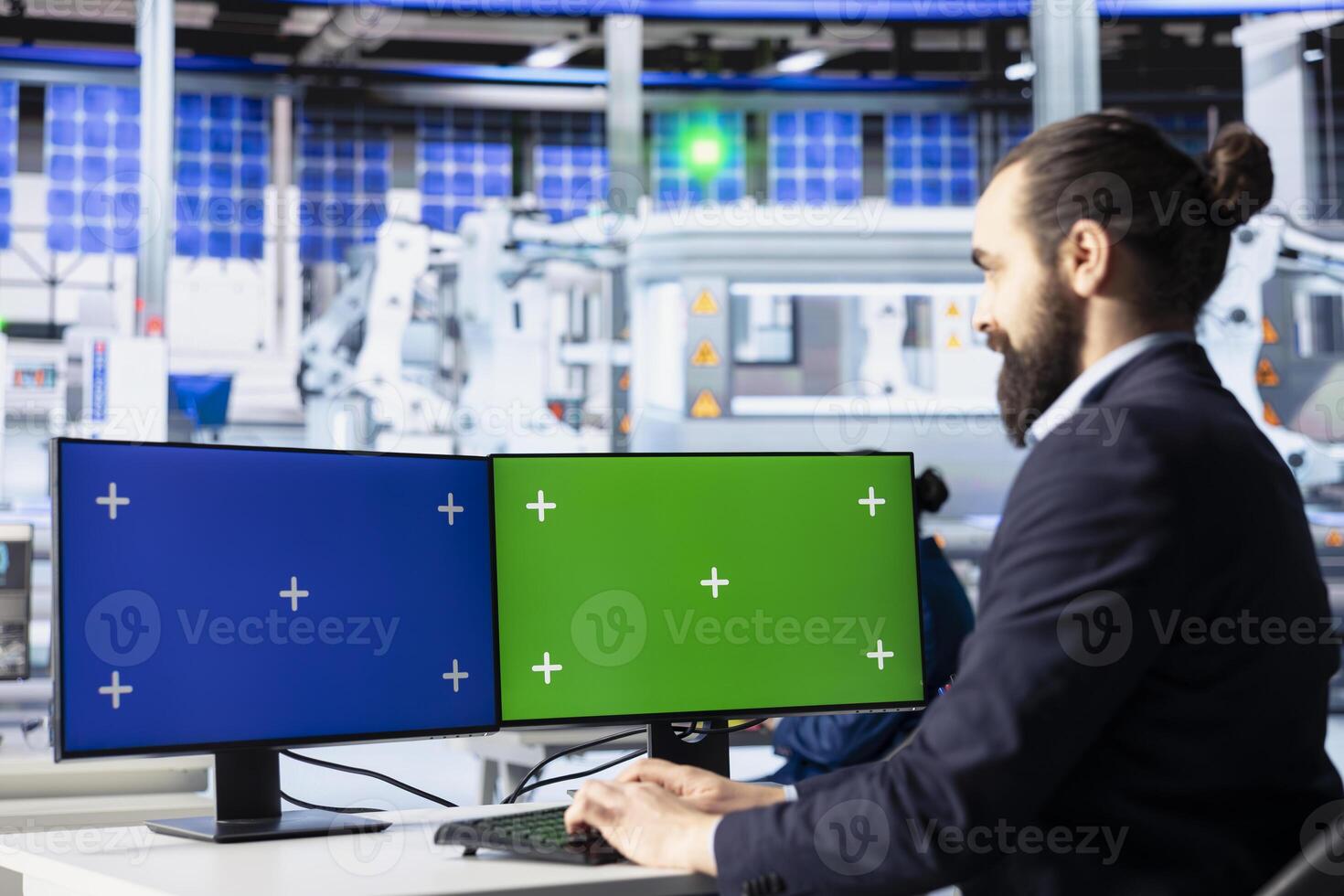 Man in solar panel plant adjusting robotic machinery settings through isolated screen computer displays. Photovoltaics factory expert diagnosing gear performance issues using mockup PC monitors photo