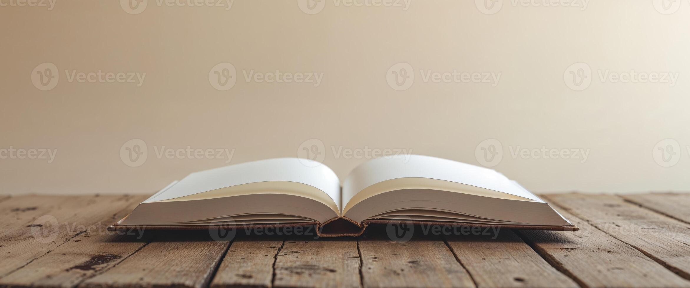Open Book with Blank Pages on Wooden Table Ready for Writing photo