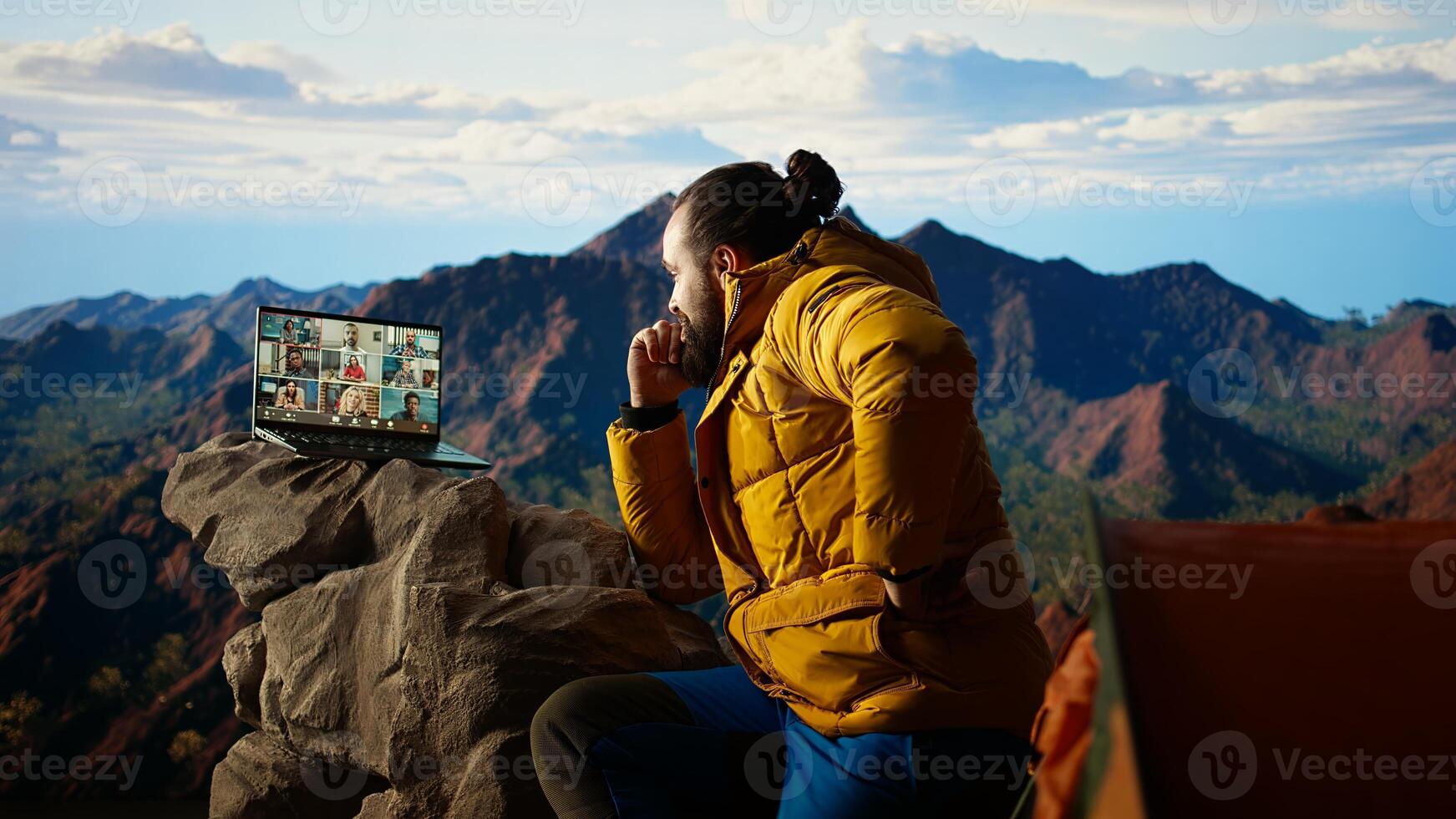 Entrepreneur uses high speed internet connection on mountain top, enjoying the call with a scenic landscape. Young hiker having an internet dependency and being workaholic. Camera A. photo