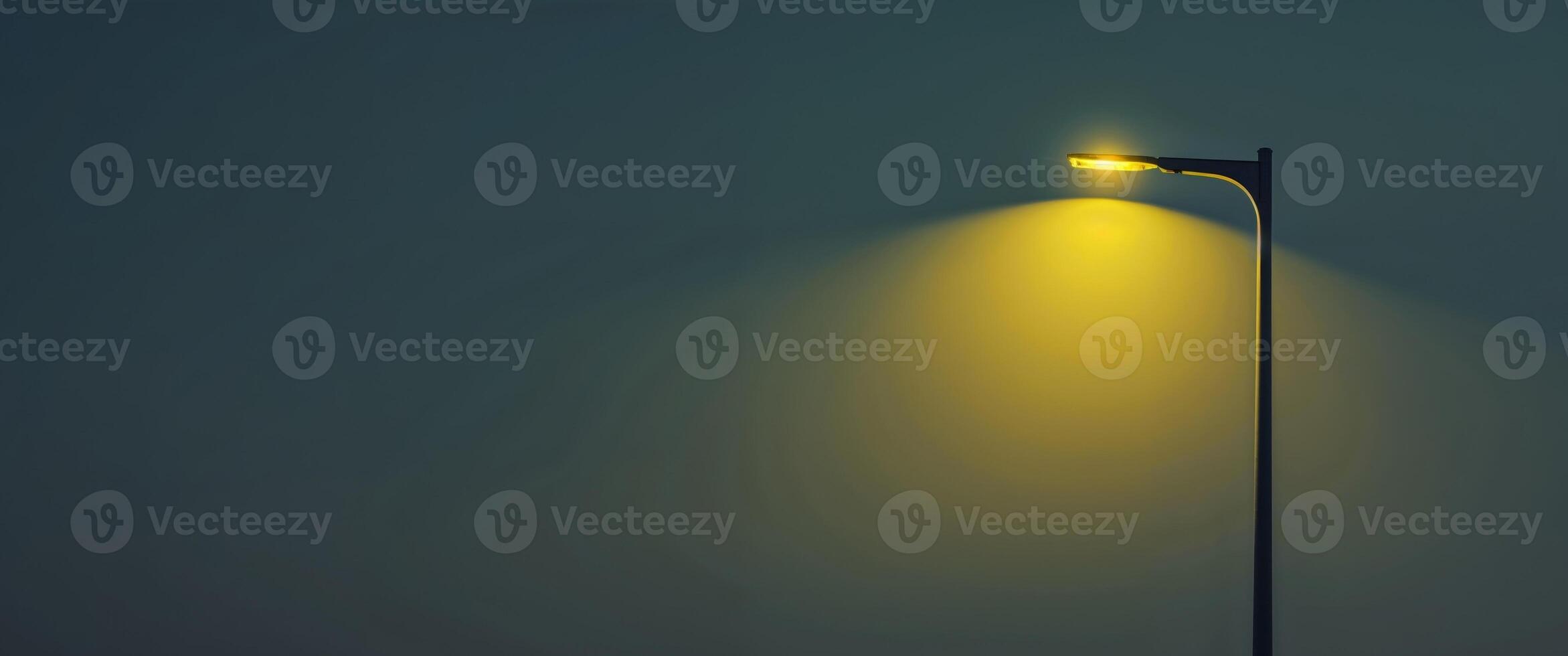 A street lamp with a yellow light is lit up in the night photo